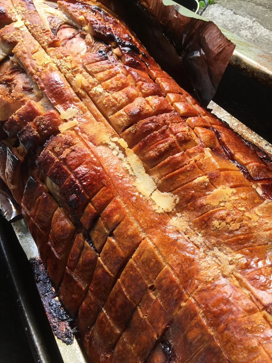 Two golden retrievers eyeing the freshly carved hog roast — Trufflehunters, properly fun